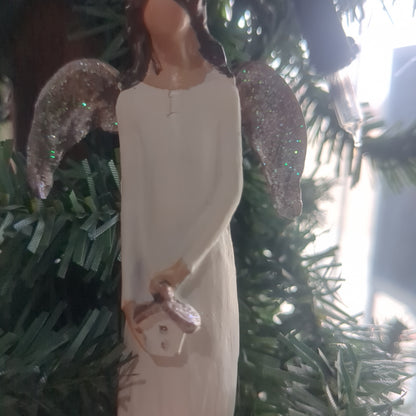 Angel holding a birdhouse ornament