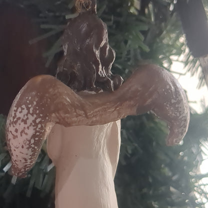 Angel holding a birdhouse ornament