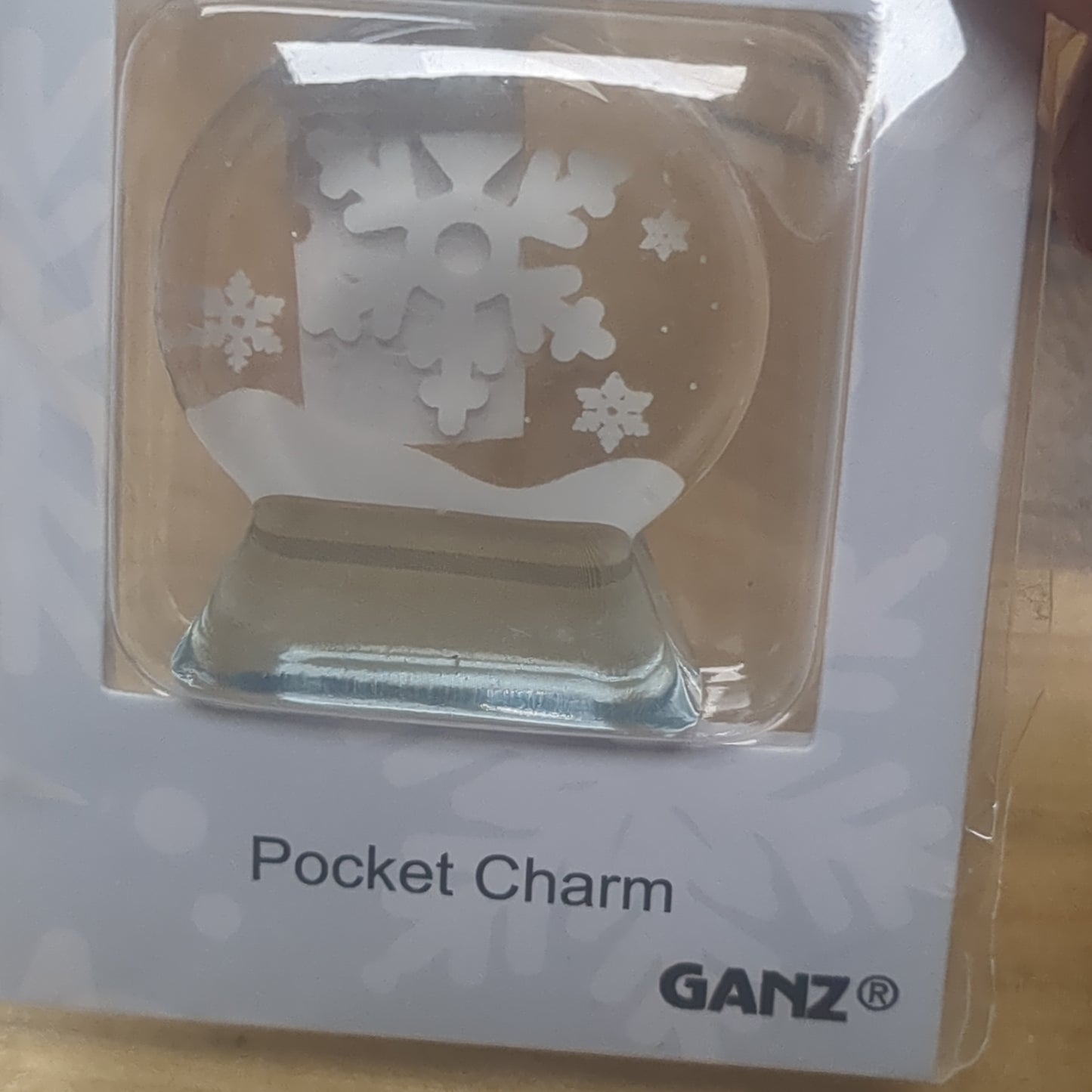 Pocket charm snow globe appearance with snowflake inside. Love warms even on the coldest of days