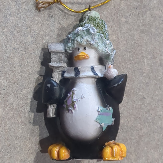 Penguin ornament with a bird and a birdhouse