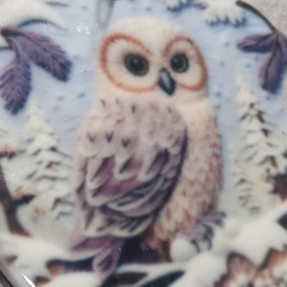 Ceramic ornament with an owl sitting on a branch, it appears 3D but it is not