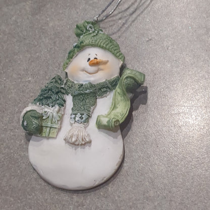 Polycrylic snowman ornament with a scroll and gift - green