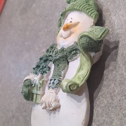 Polycrylic snowman ornament with a scroll and gift - green