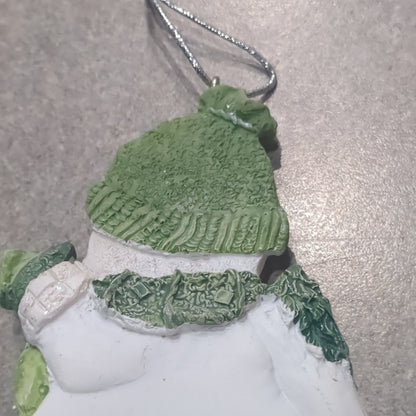 Polycrylic snowman ornament with a scroll and gift - green