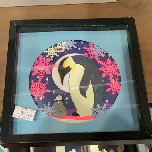 5 1/2” x 5 1/2” black shadow box frame with paper cut penguins scene