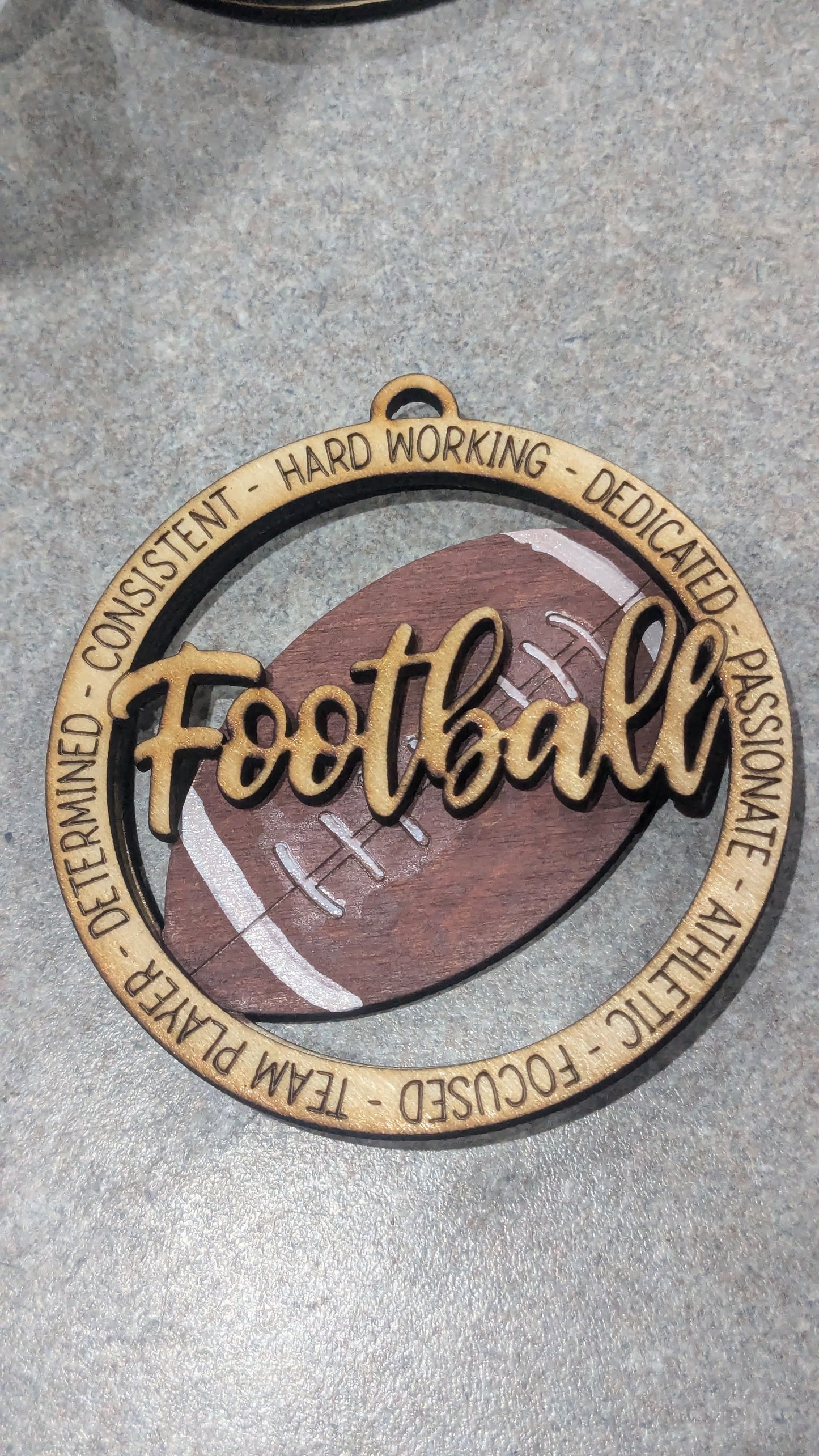 Wooden ornament or car charm.  Football